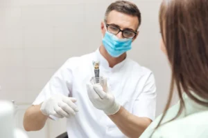 dentist explaining the process of Implant Crowns Denville NJ