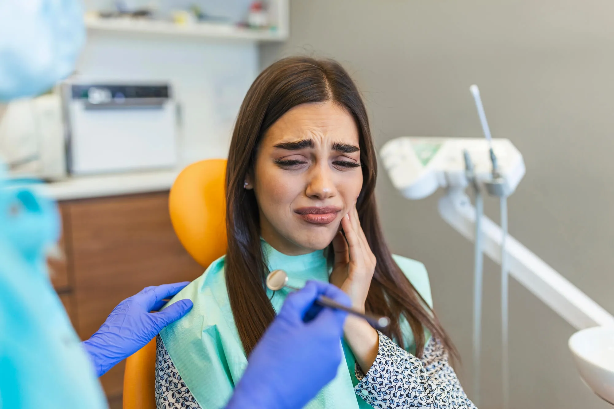 patient complaining of tooth pain to a Root Canal Specialist Denville NJ